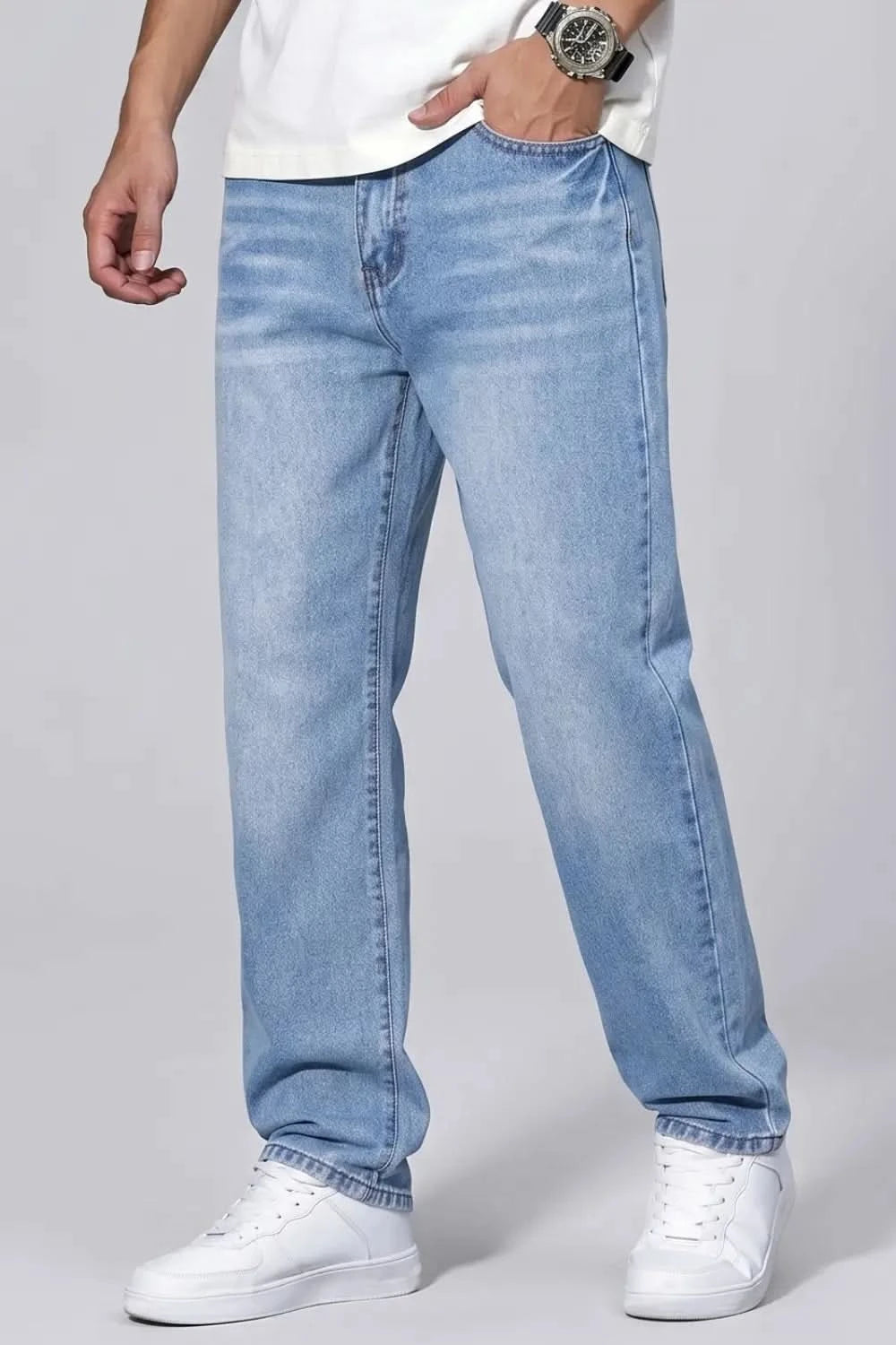 Light blue jeans worn by a person on a gray background
