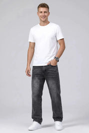 Man wearing a white t-shirt and black jeans on a gray background