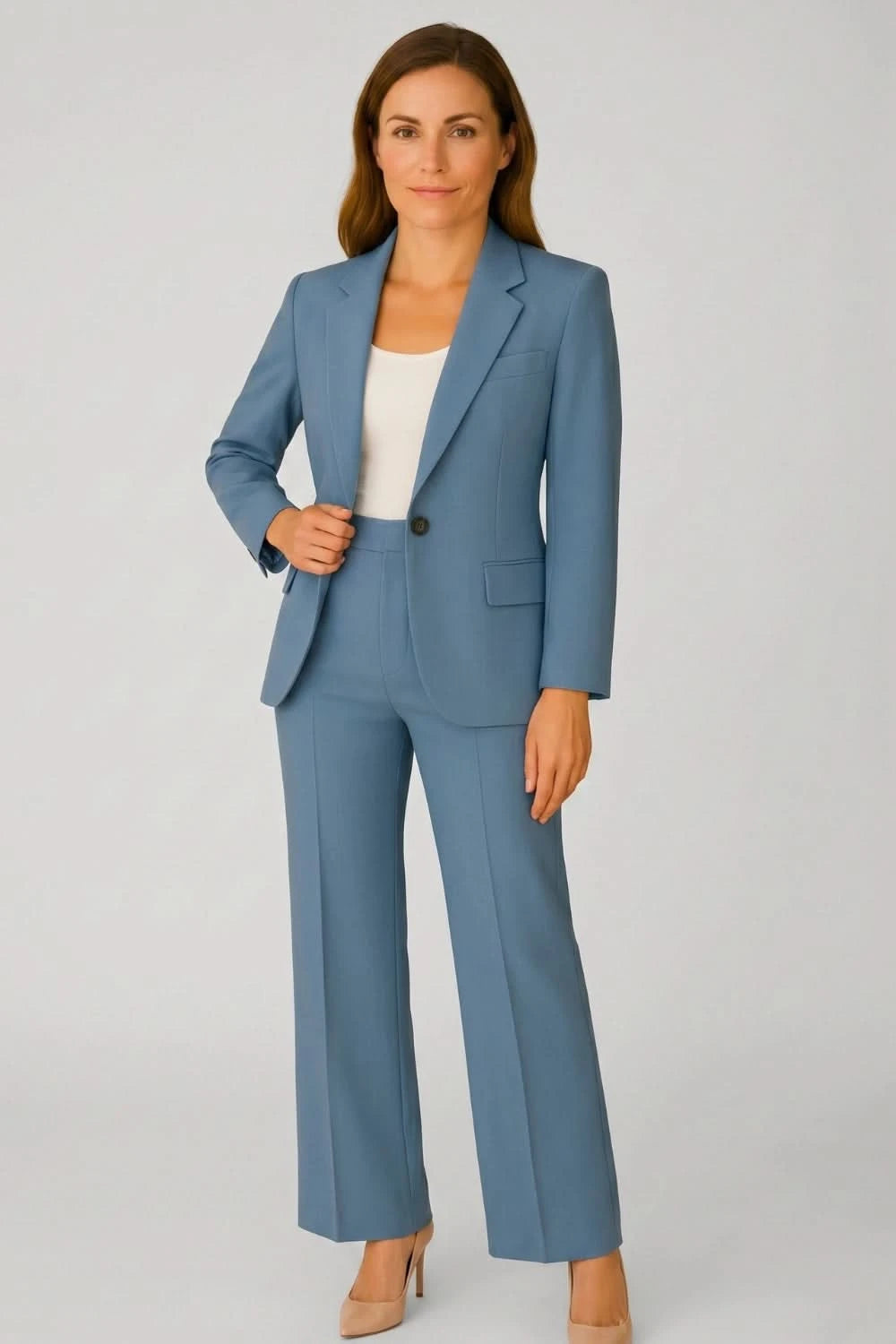 Woman wearing a blue suit on a gray background