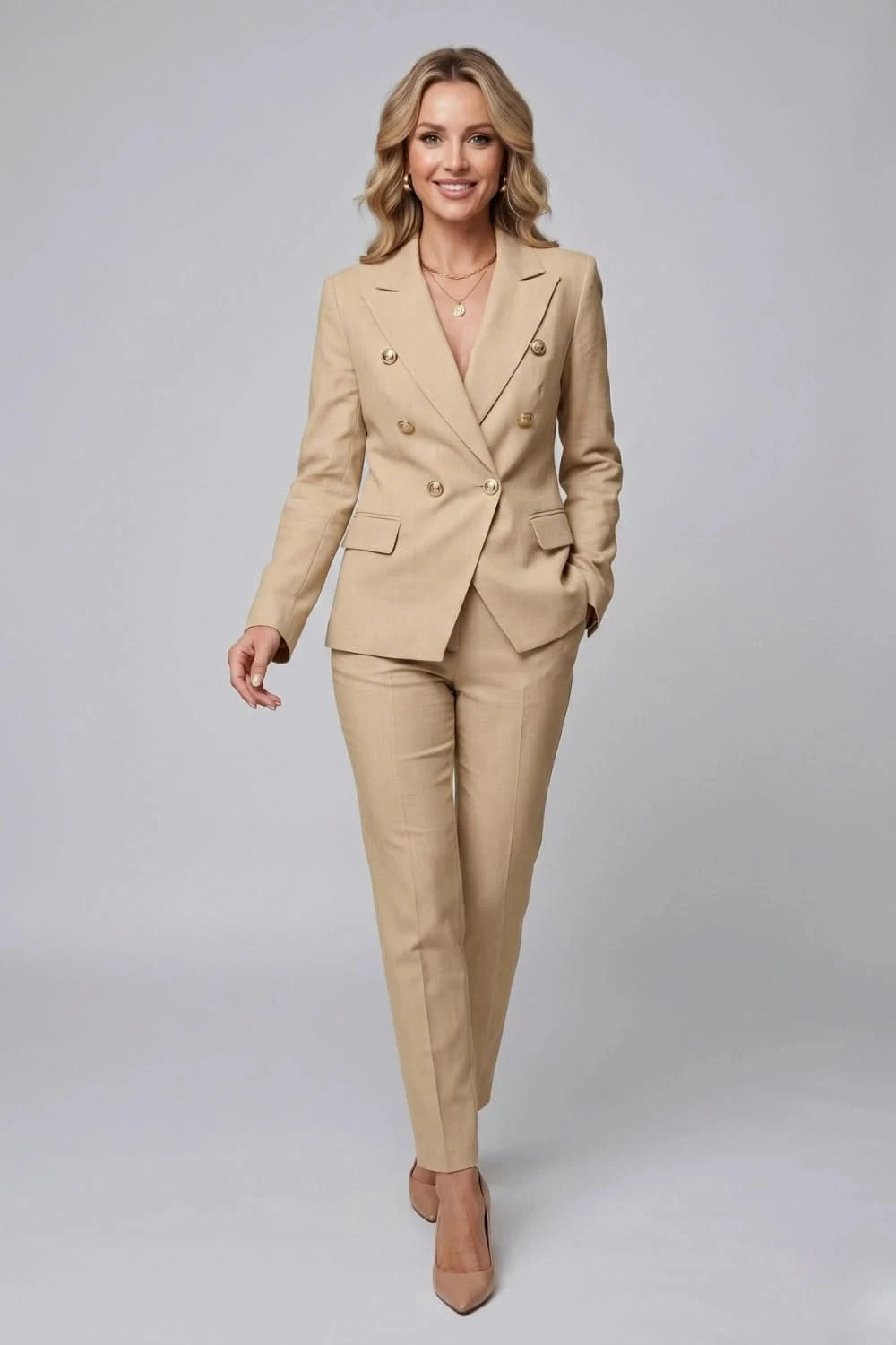 Woman wearing a beige suit on a gray background