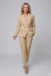 Woman wearing a beige suit on a gray background