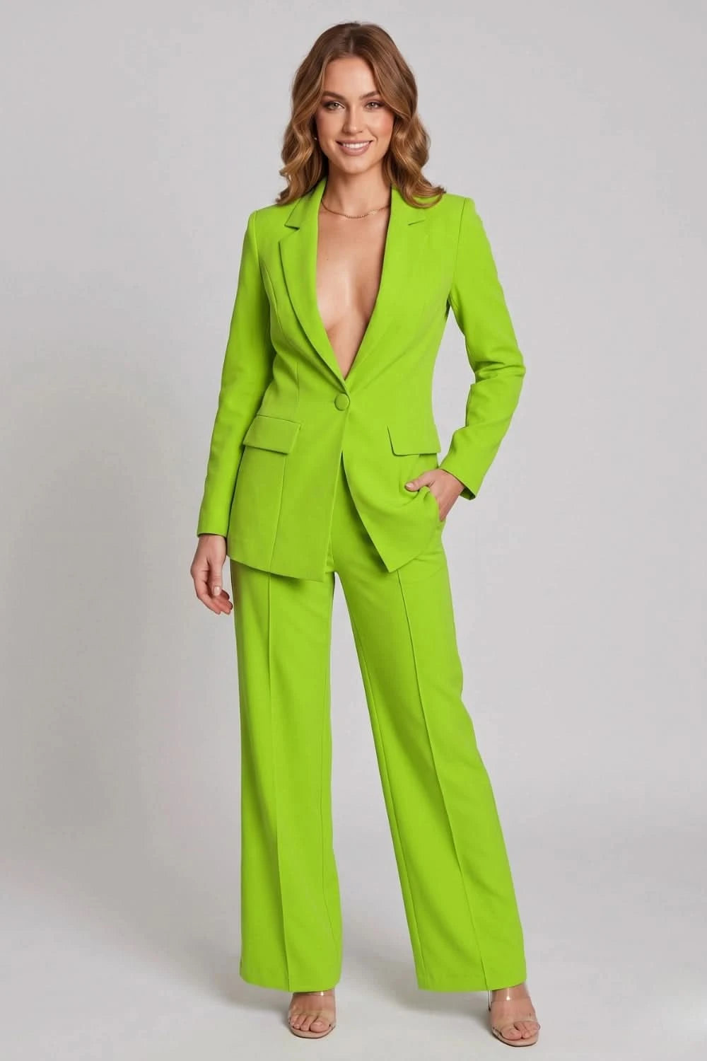 Woman wearing a bright green suit on a plain background