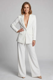 Woman wearing a white suit on a gray background