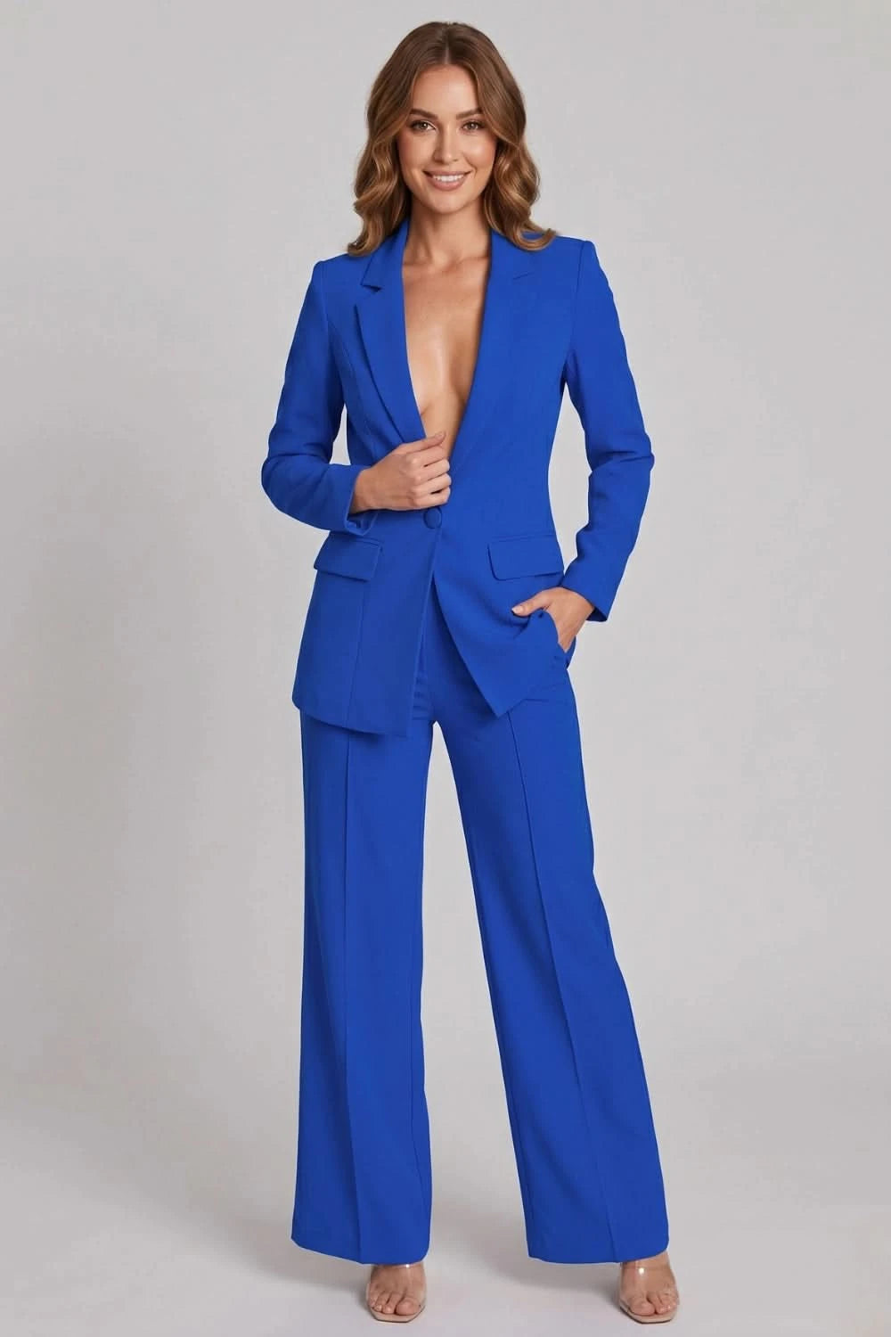 Woman wearing a blue suit on a gray background