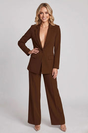 Woman wearing a brown suit on a plain background