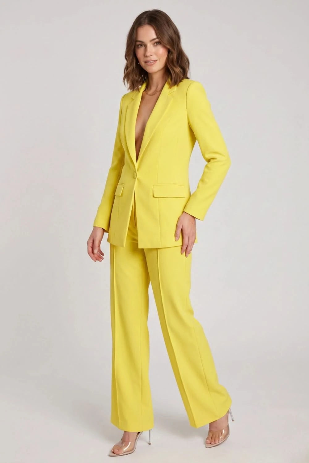 Woman wearing a bright yellow suit on a white background