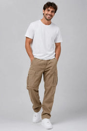 Man wearing a white t-shirt and beige cargo pants on a gray background