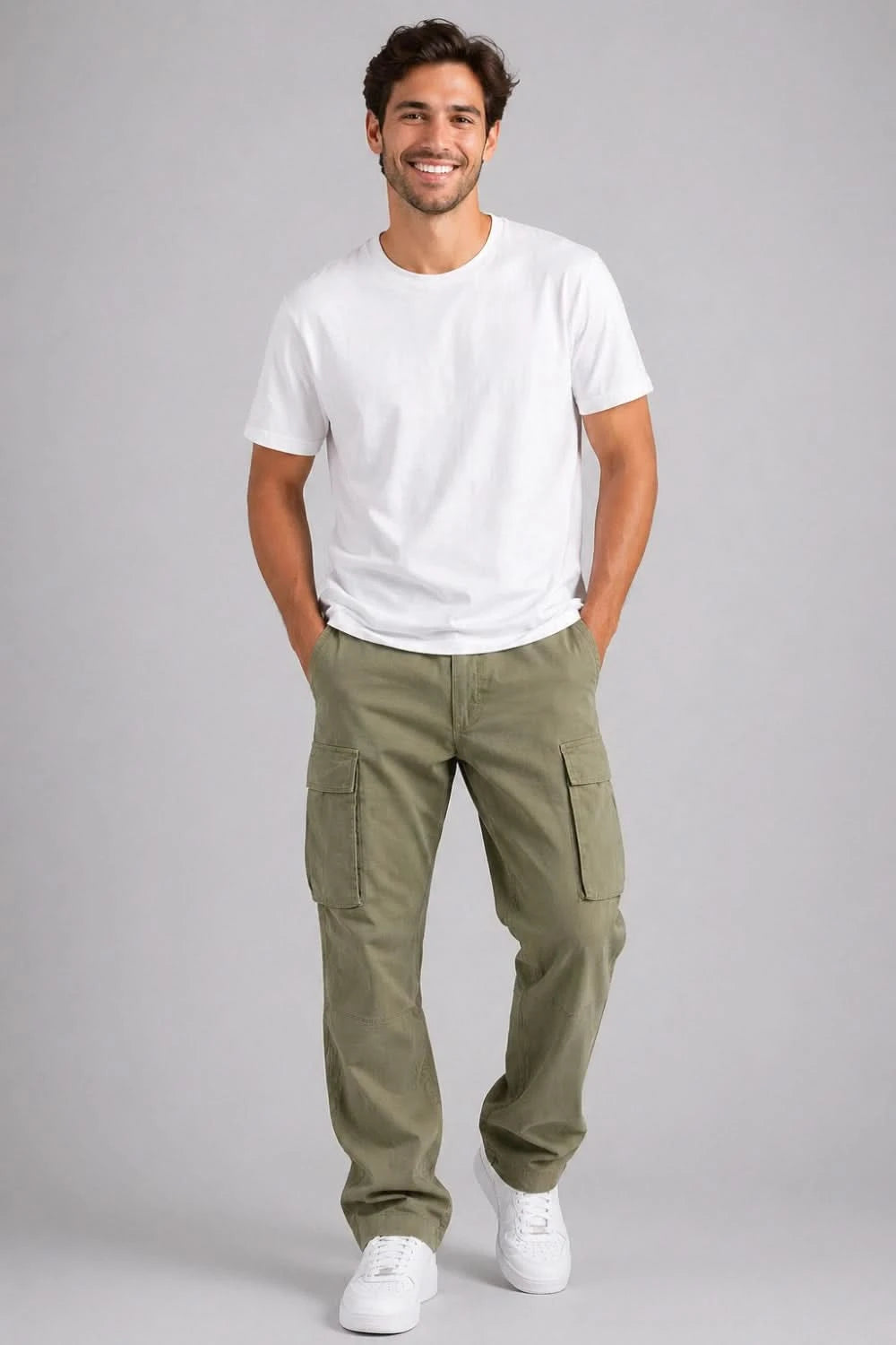 Man wearing a white t-shirt and green cargo pants on a gray background