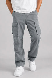 Person wearing gray cargo pants on a plain background