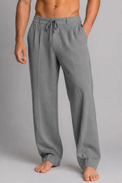 Gray sweatpants worn by a person on a gray background