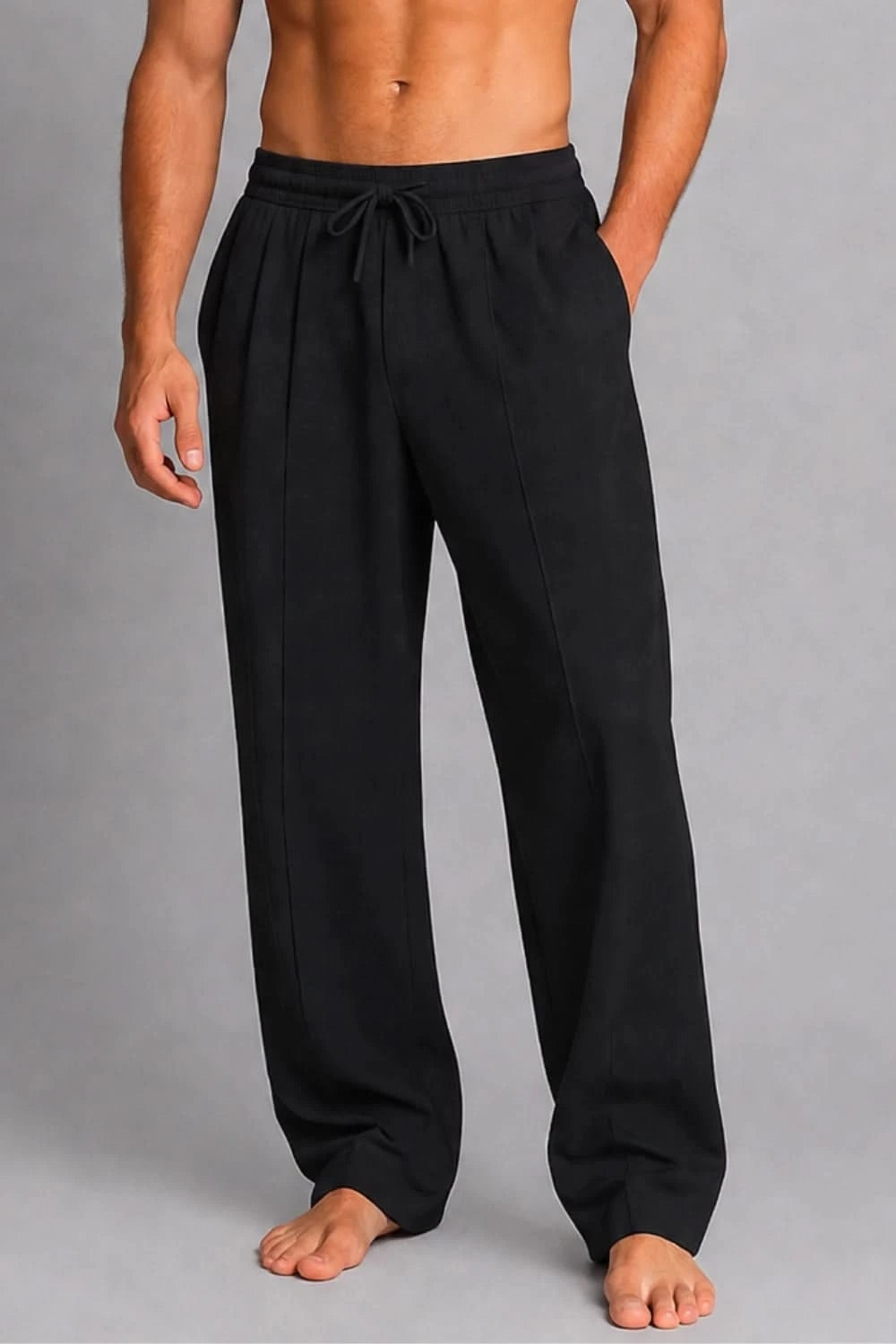 Person wearing black pants on a gray background