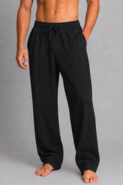 Person wearing black pants on a gray background